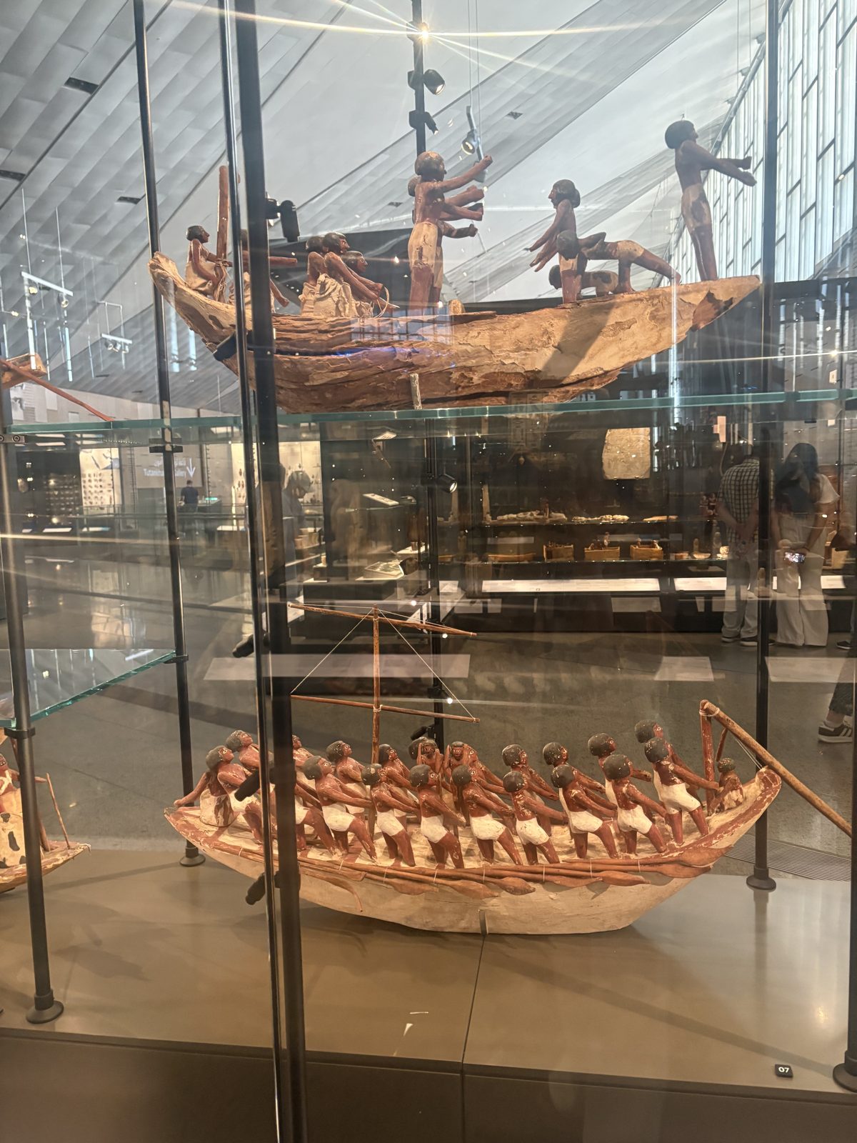 Model solar boats displayed in glass cases