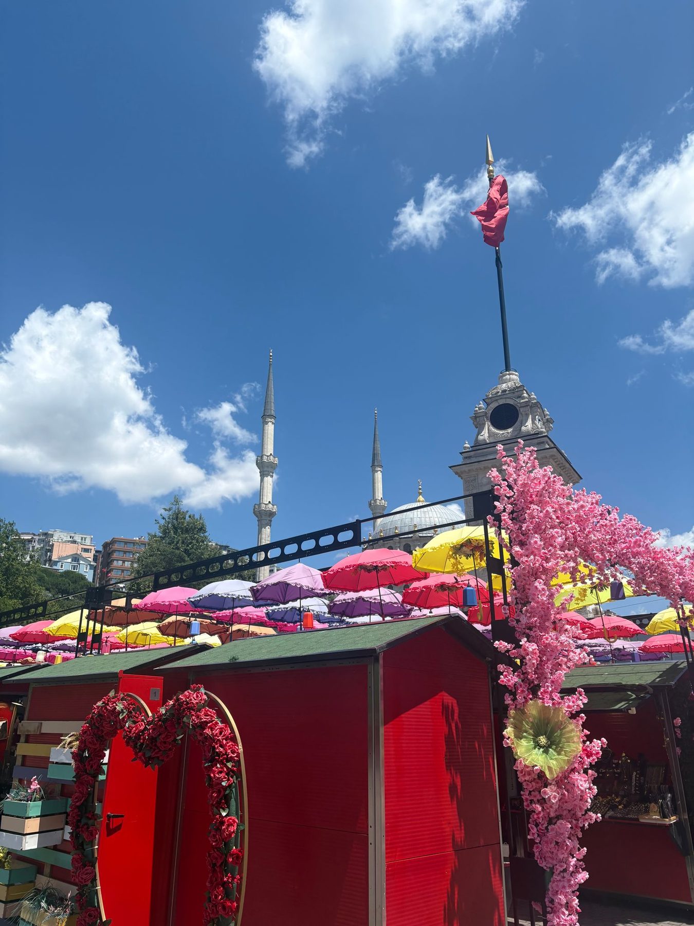 A cafe front covered in artificial flowers and umbrellas in Istanbul