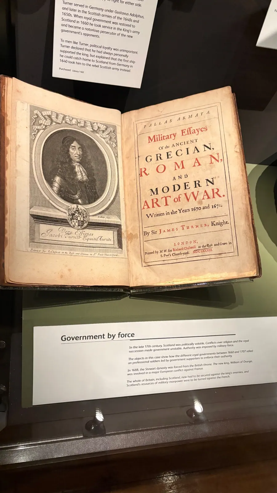A 1683 book, Pallas Armata, open in a museum case