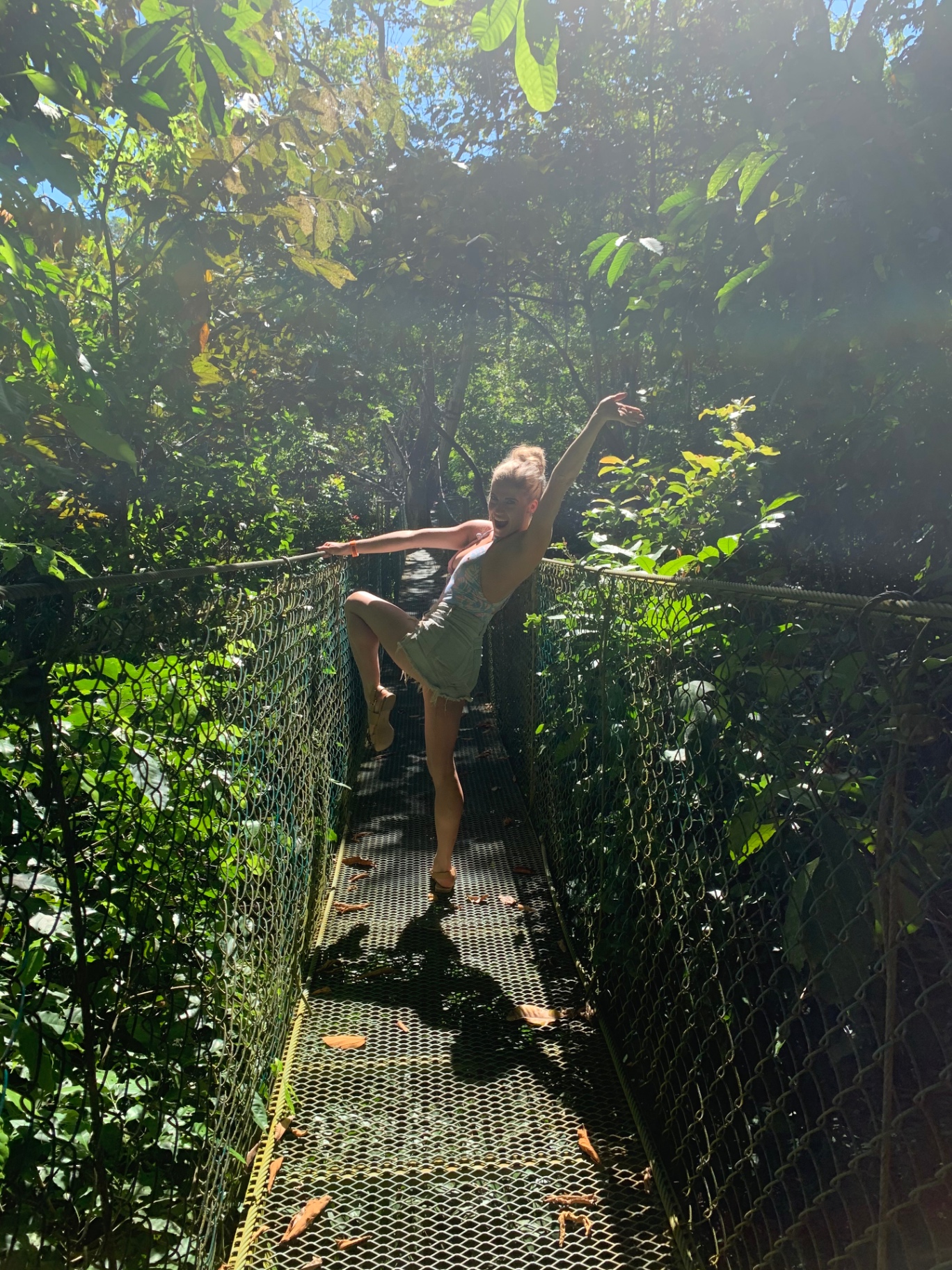 Dancing on a suspension bridge surrounded by rainforest