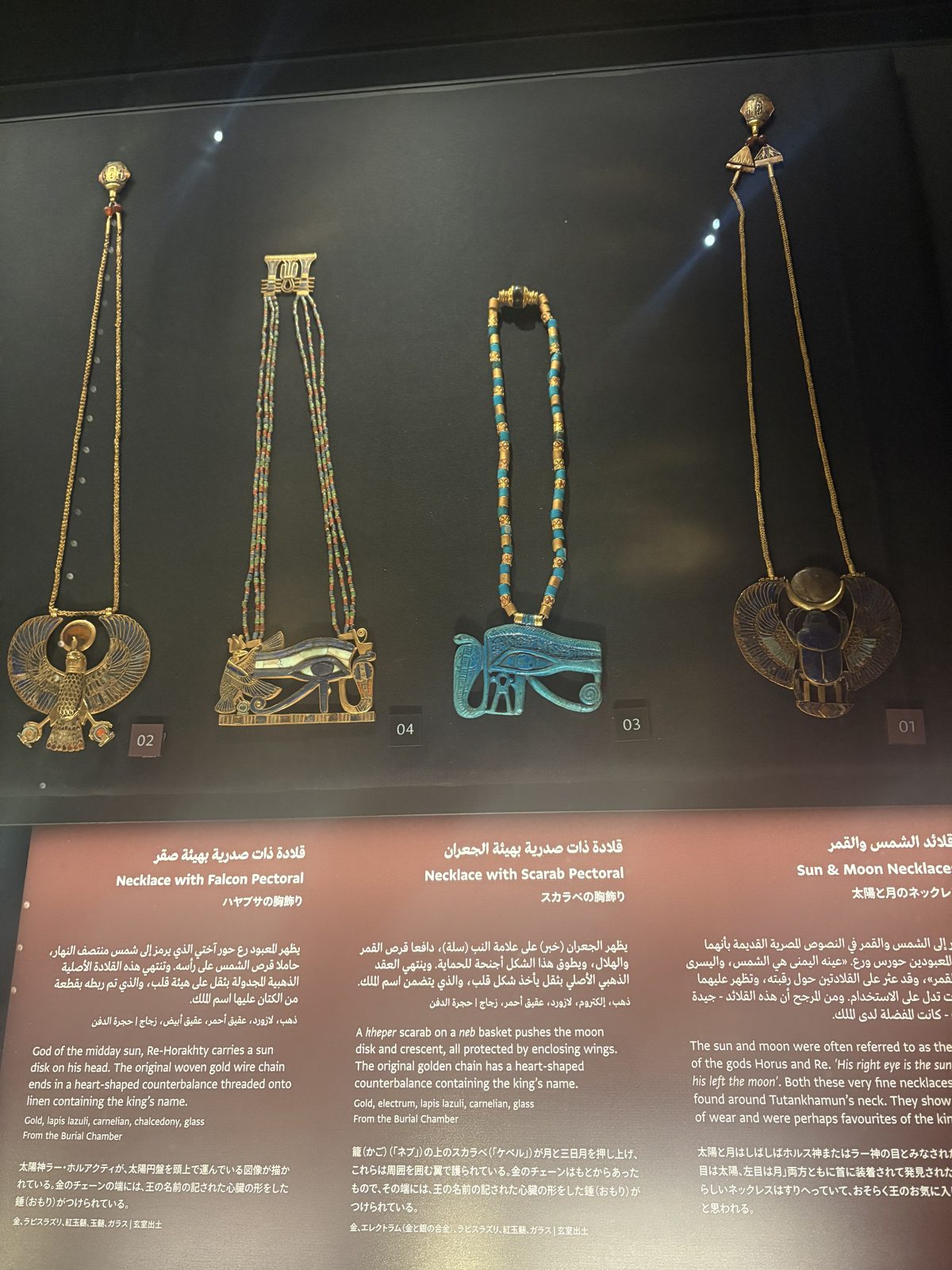 Ancient Egyptian necklaces with ankh and scarab amulets in a case