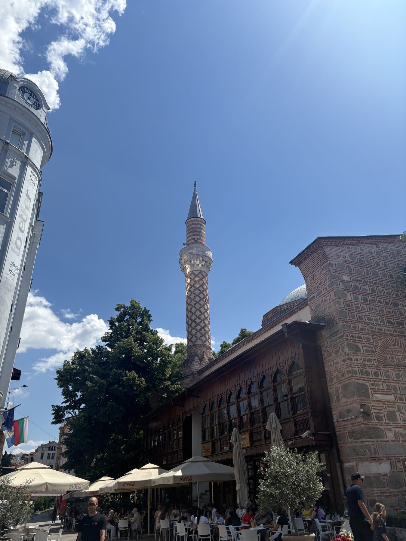 The minaret of Dzhumaya Mosque above a cafe terrace in Plovdiv