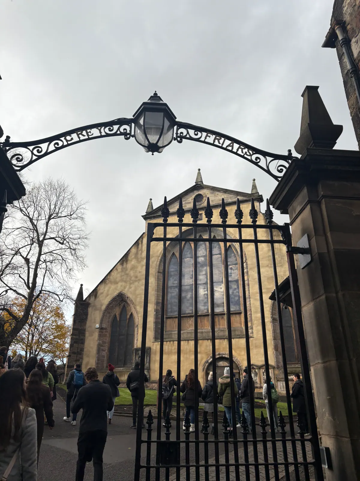 The wrought-iron Greyfriars gate and lamp with the kirk beyond