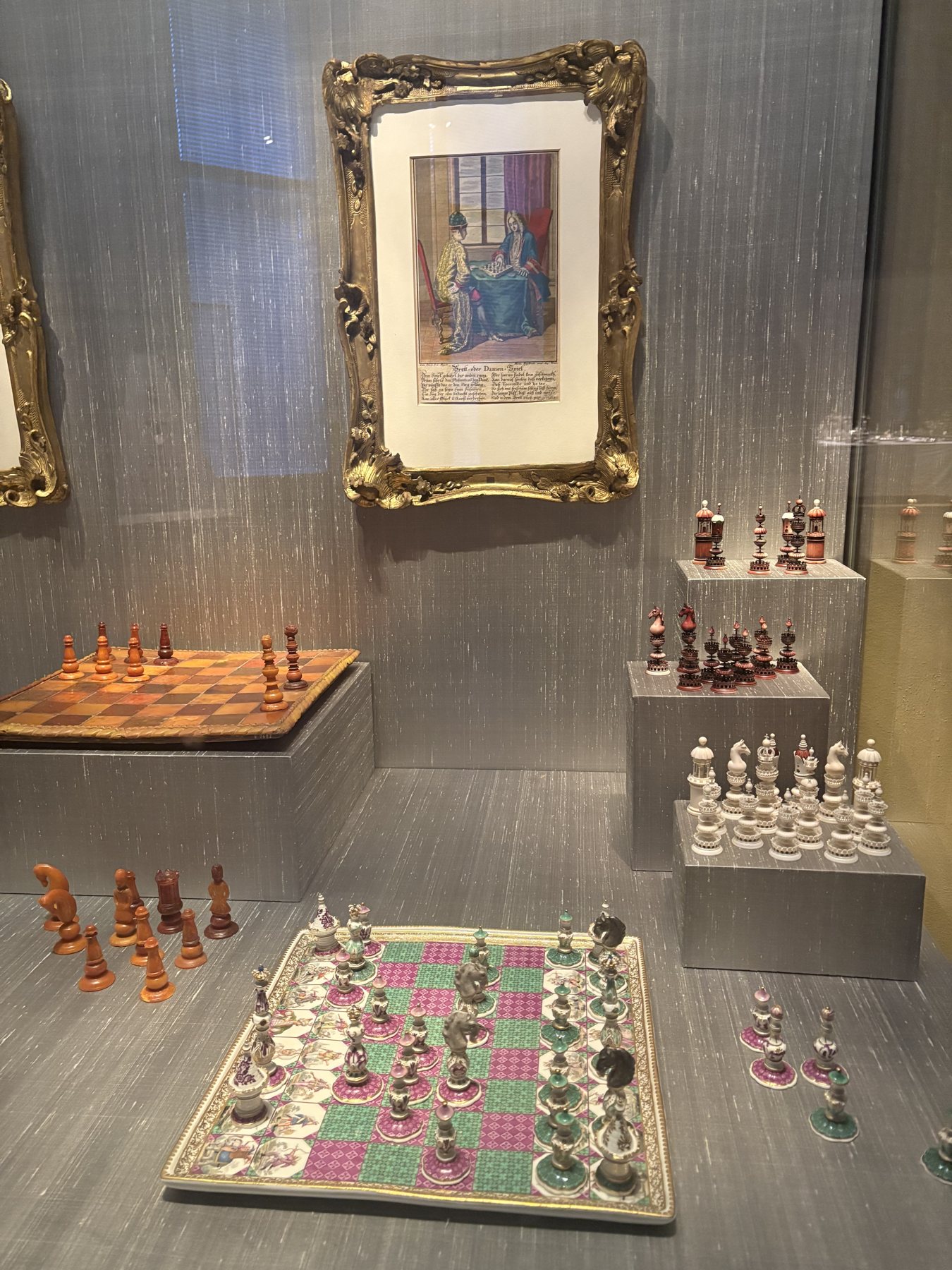 Historic chess and board game sets displayed in a museum case