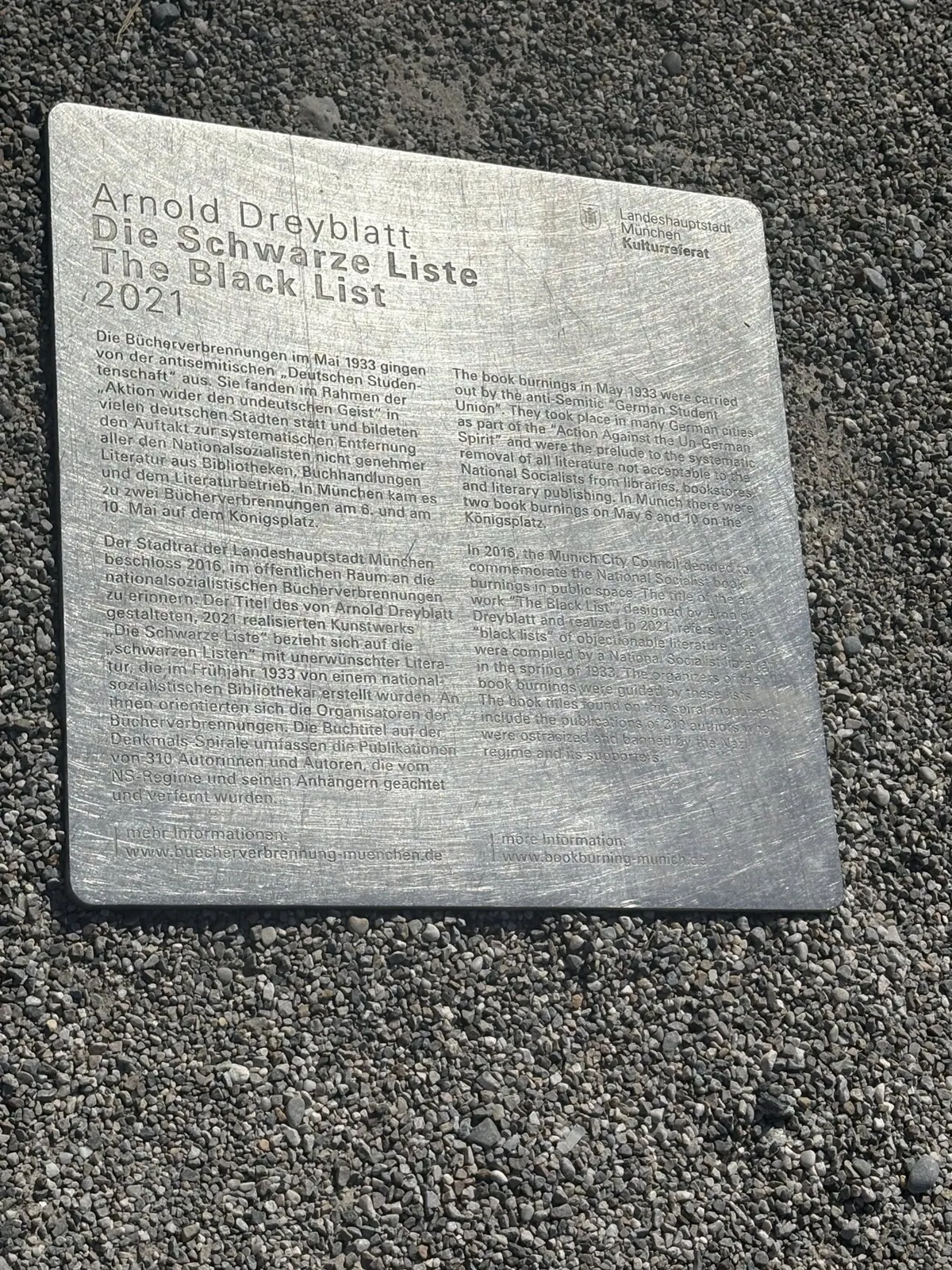Arnold Dreyblatt's The Black List memorial plaque set into gravel in Munich