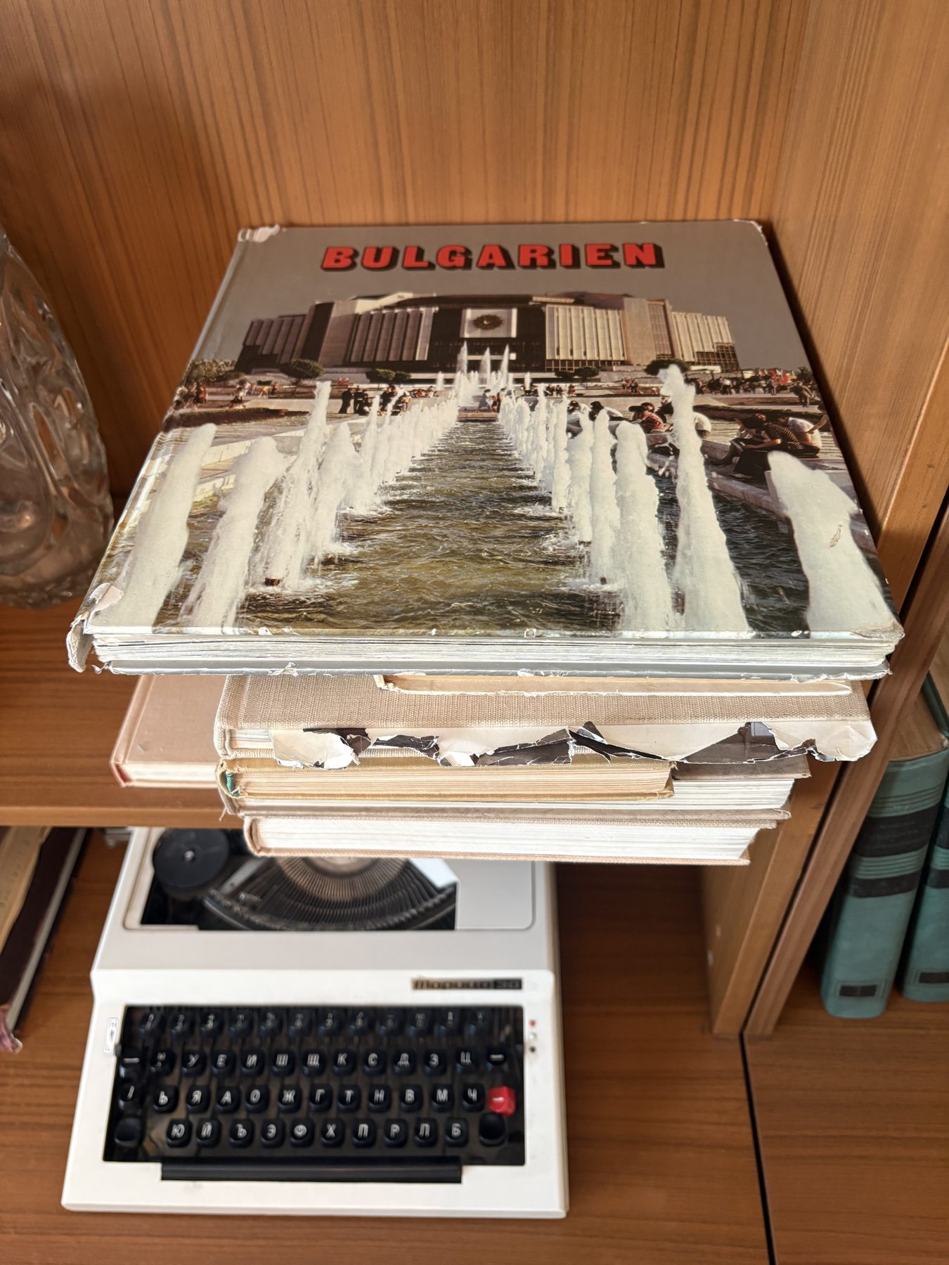 Old Bulgarian books and a typewriter on a shelf in the museum apartment