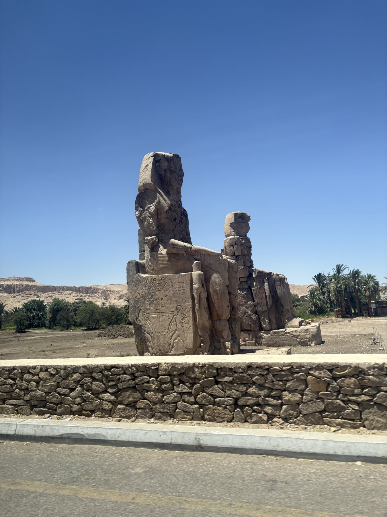 The Colossi of Memnon standing in the plain