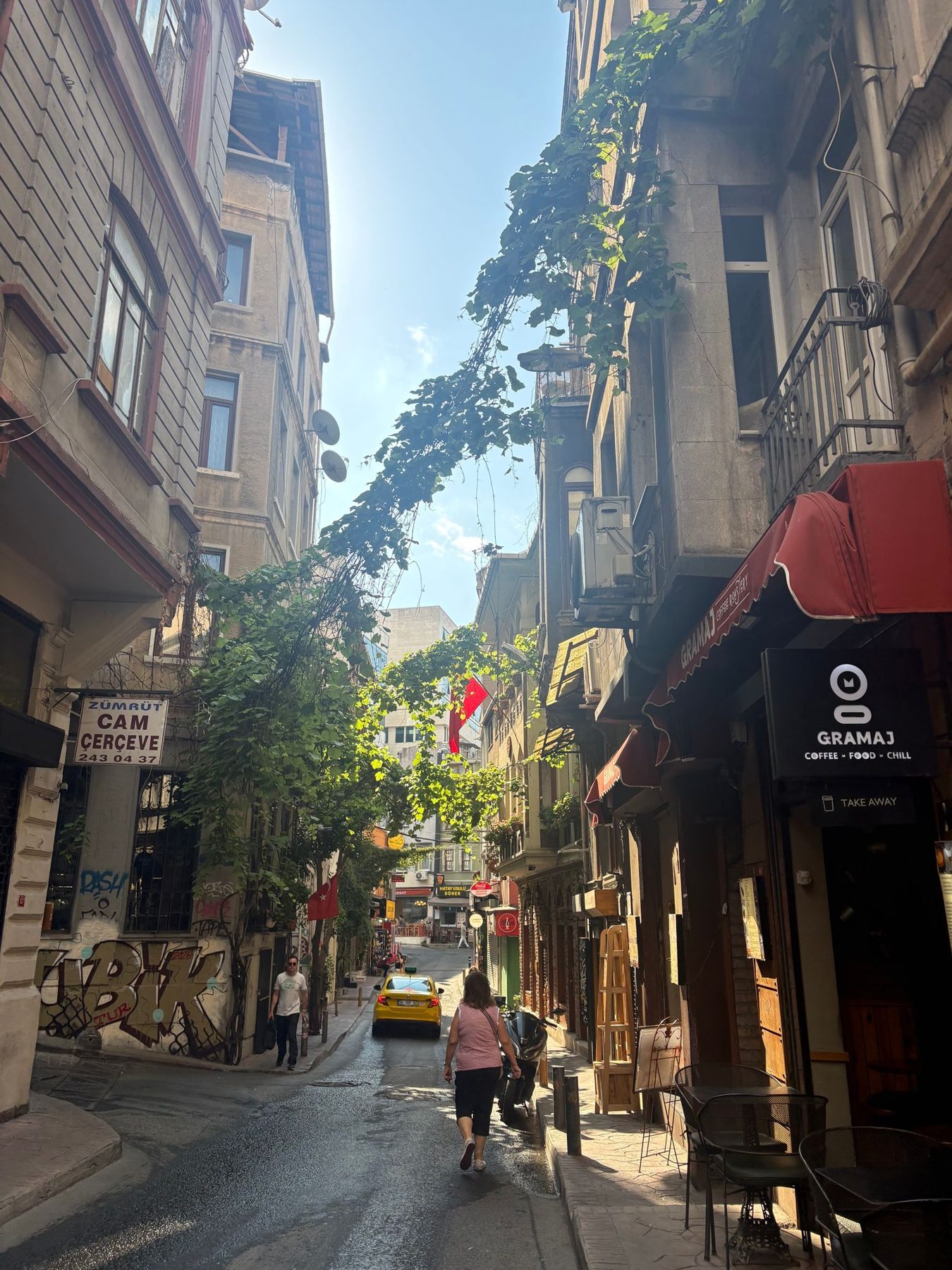 A narrow Istanbul lane with awnings and old apartment buildings