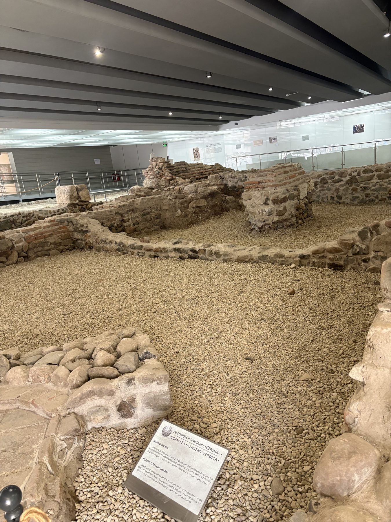 Excavated Roman stonework displayed under glass in Sofia