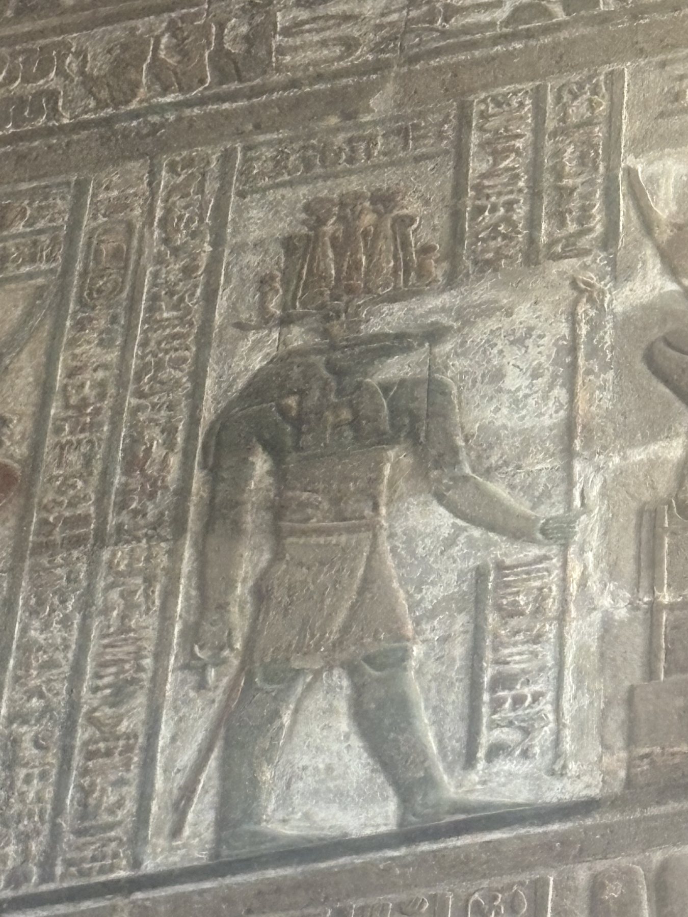 A carved deity figure on a Dendera temple wall