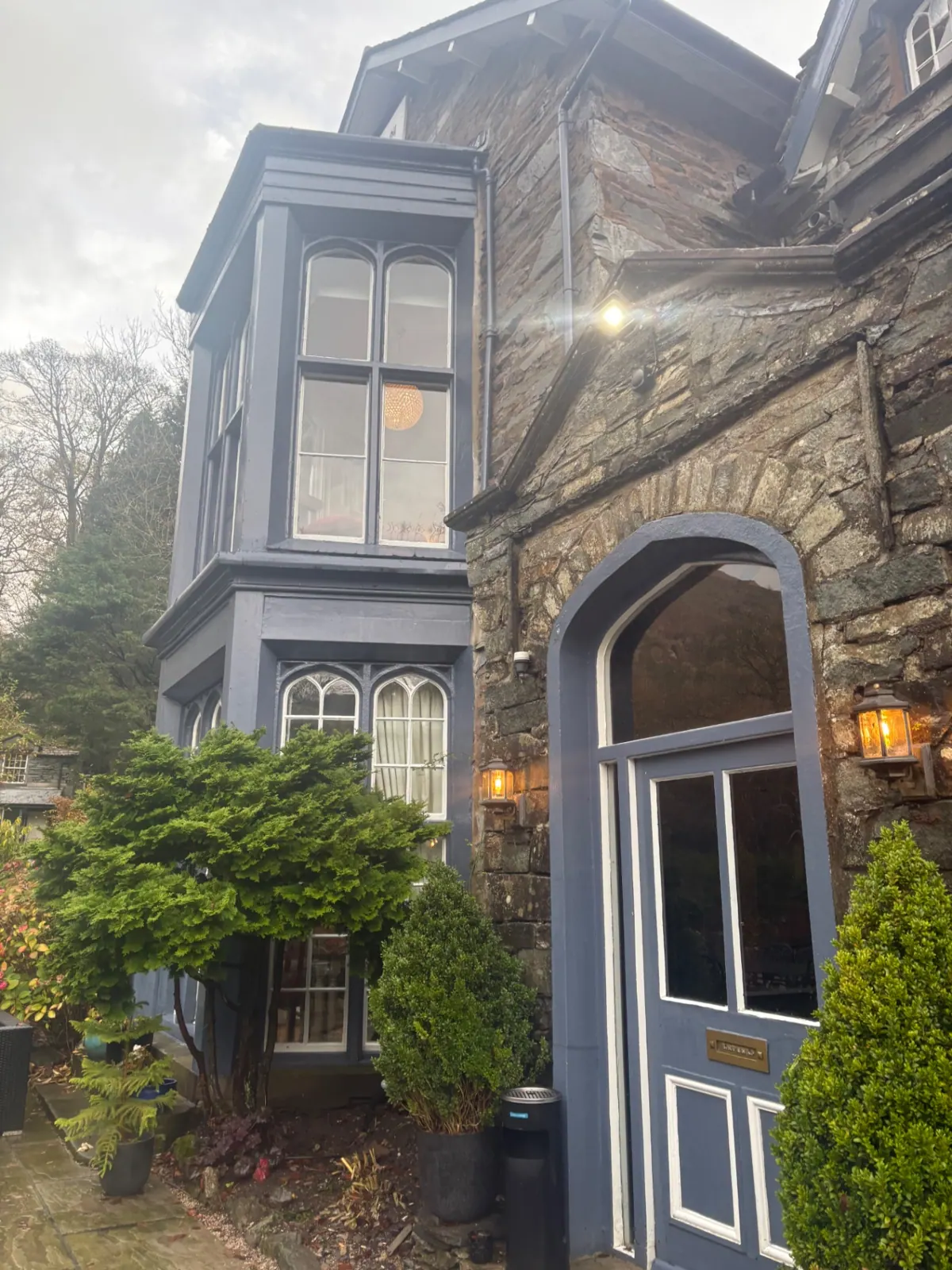The blue arched front door and bay windows of Nabb Cottage