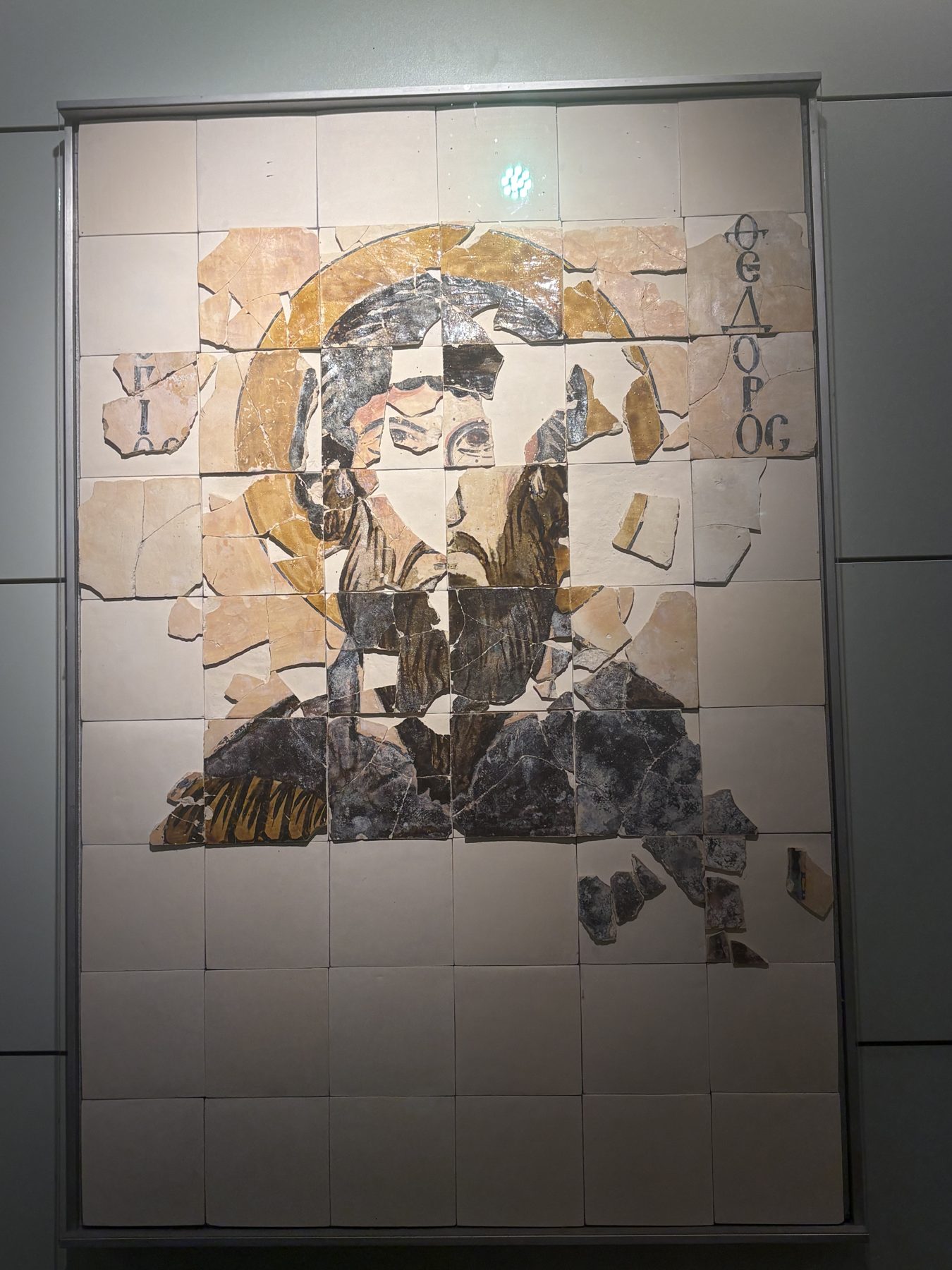 A reconstructed early Christian mosaic fragment on a museum wall
