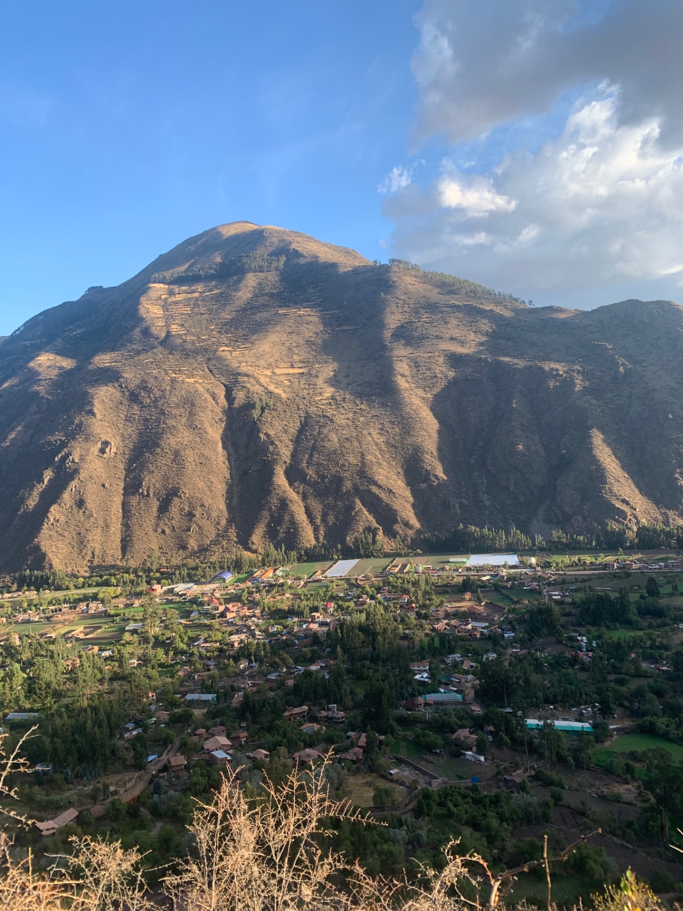 Sunlit mountain above a Sacred Valley village at golden hour