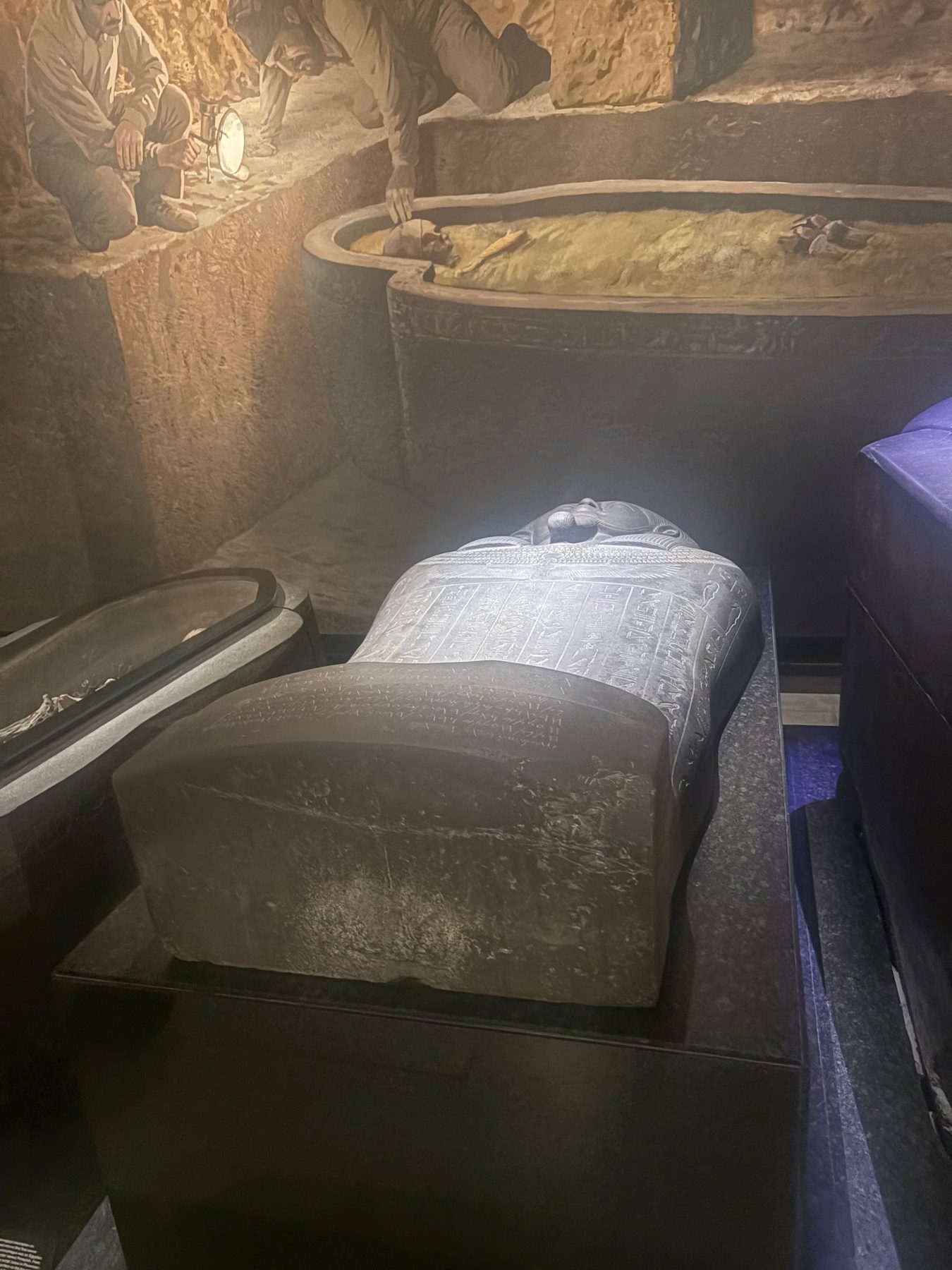 An ancient carved sarcophagus with hieroglyphs in a museum