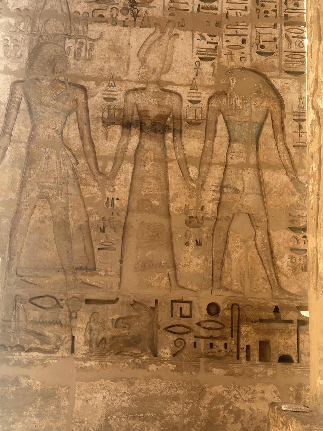 Carved hieroglyphic wall relief at shoulder height