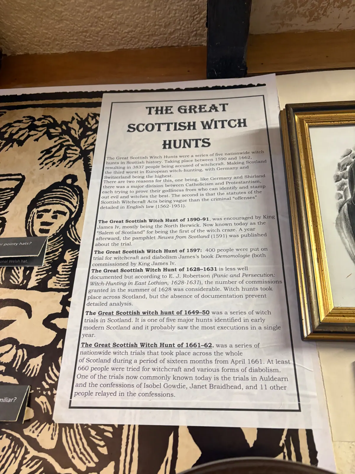 A printed panel about the Great Scottish Witch Hunts beside a woodcut of accused women