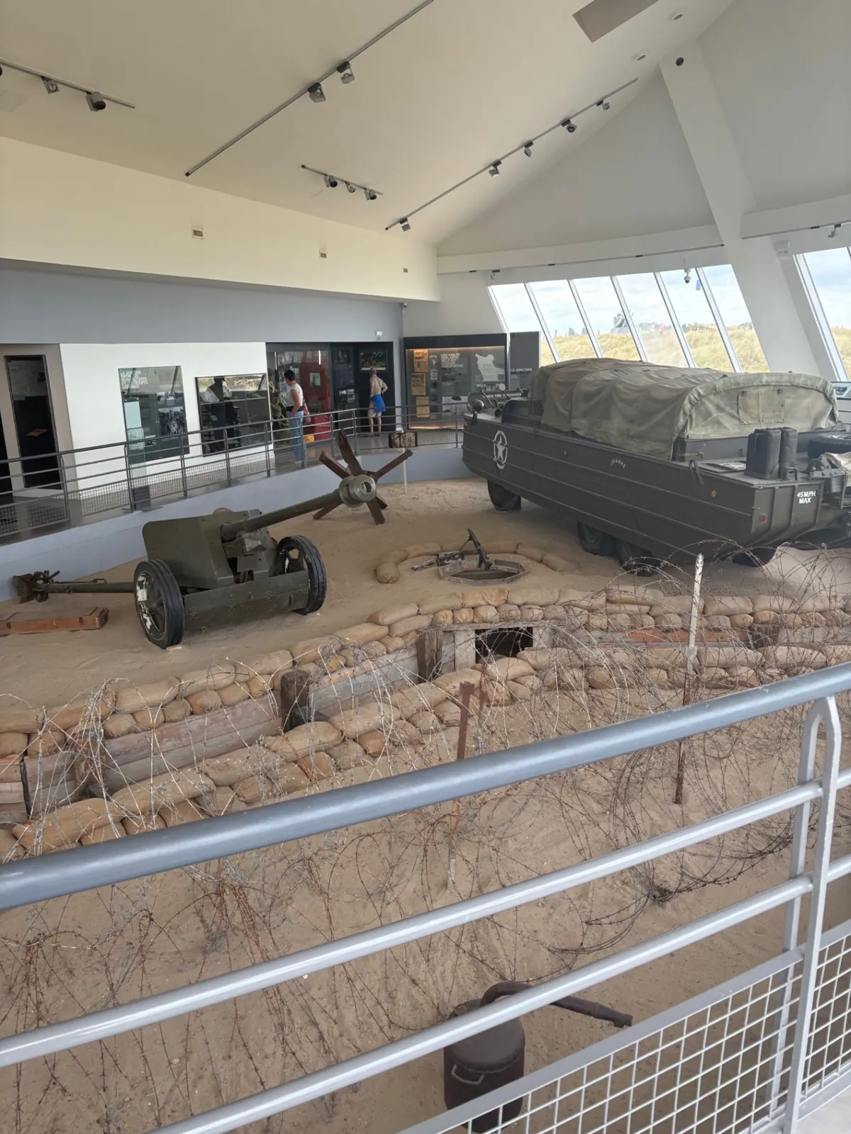 Museum interior at Utah Beach with a trench reconstruction, artillery gun and an amphibious DUKW truck