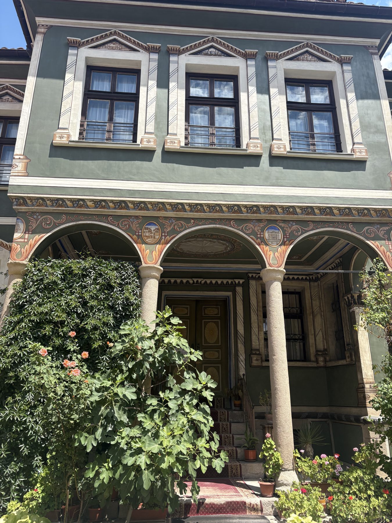 A painted Bulgarian Revival house with arched portico in Plovdiv Old Town