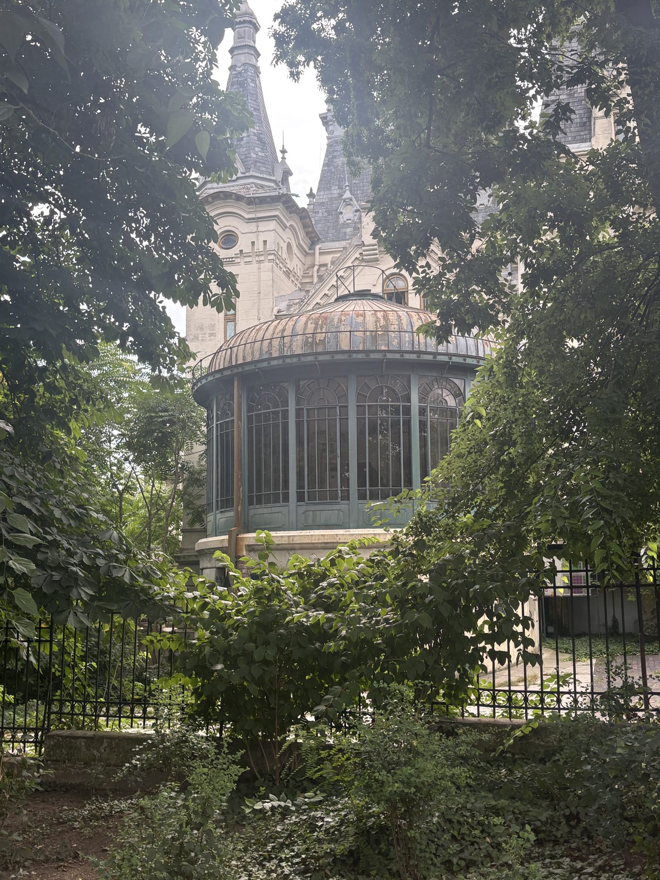 A domed pavilion framed by trees in a Bucharest park