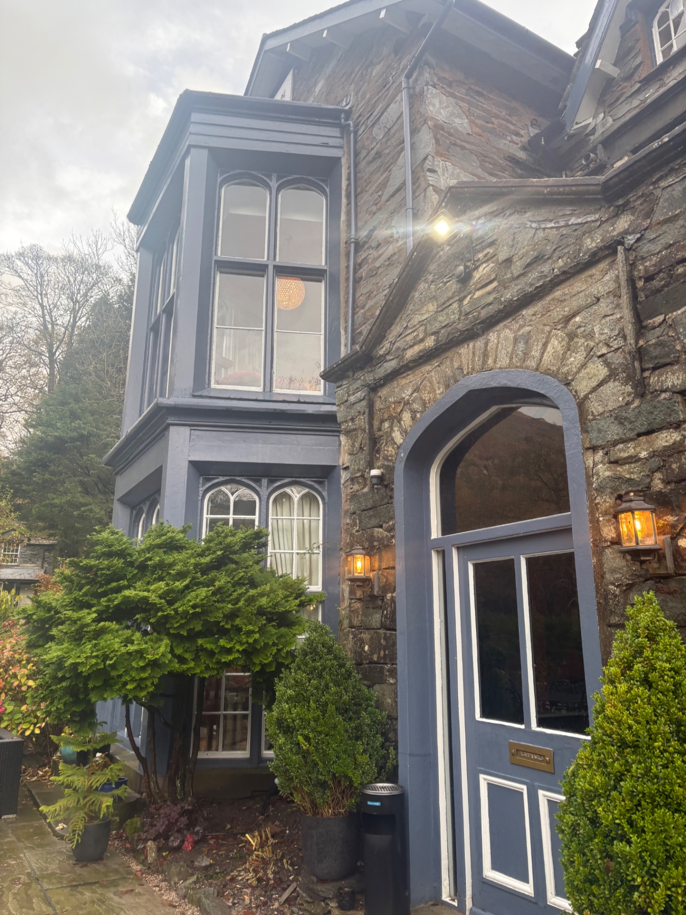 The blue arched front door and bay windows of Nabb Cottage