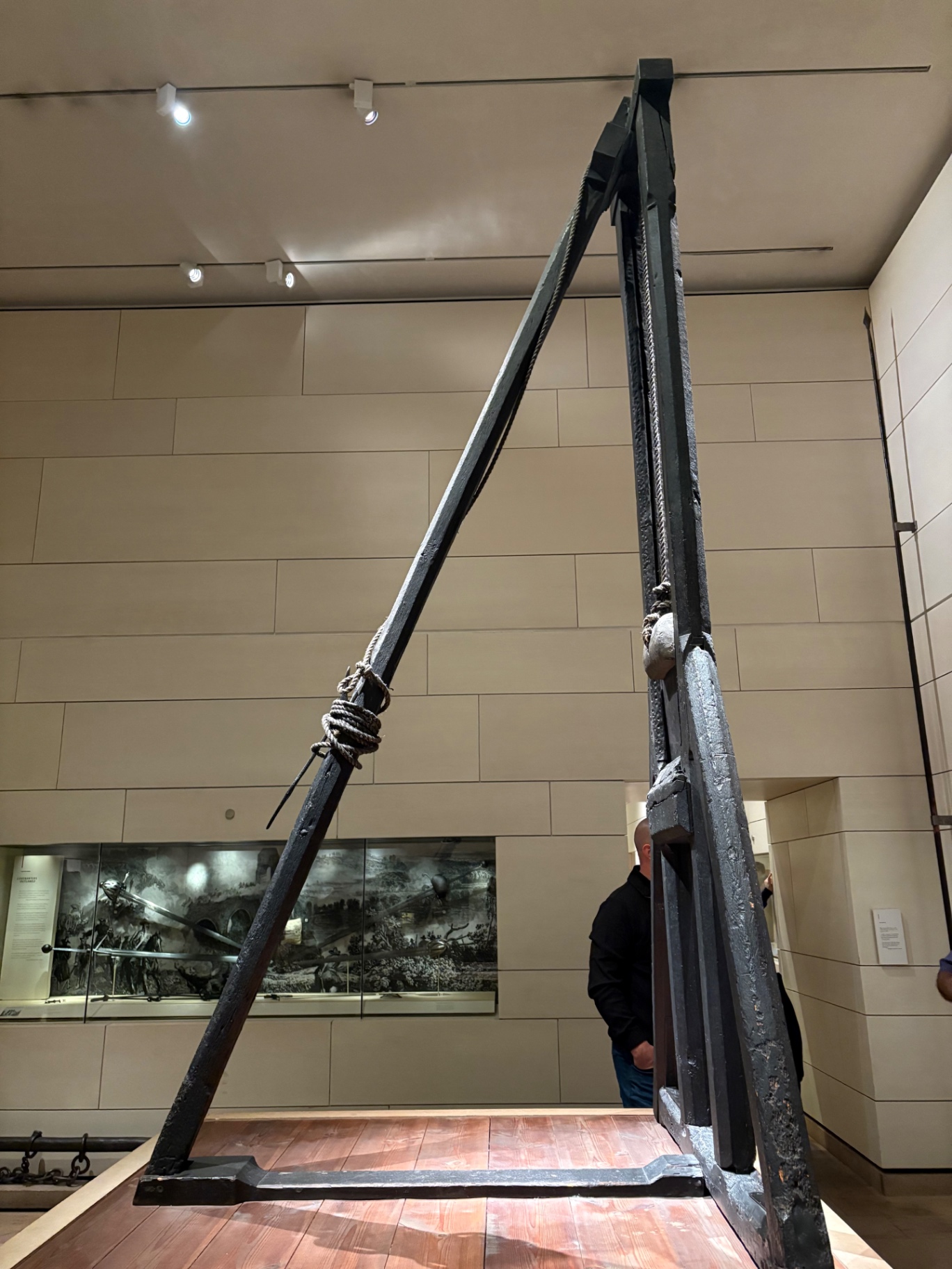 Historic wooden gallows on display in a museum gallery