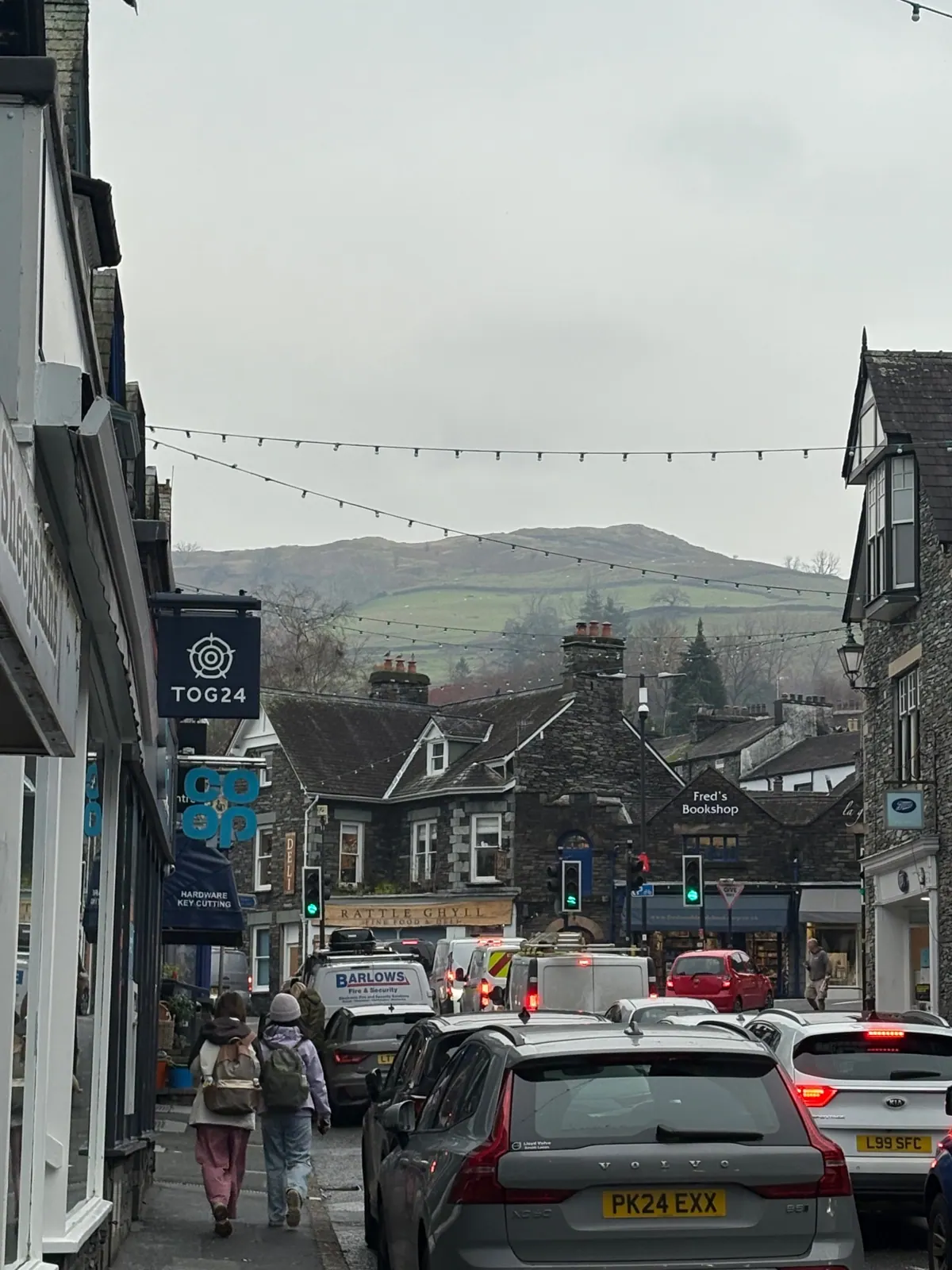 Ambleside high street with the fells rising behind the rooftops