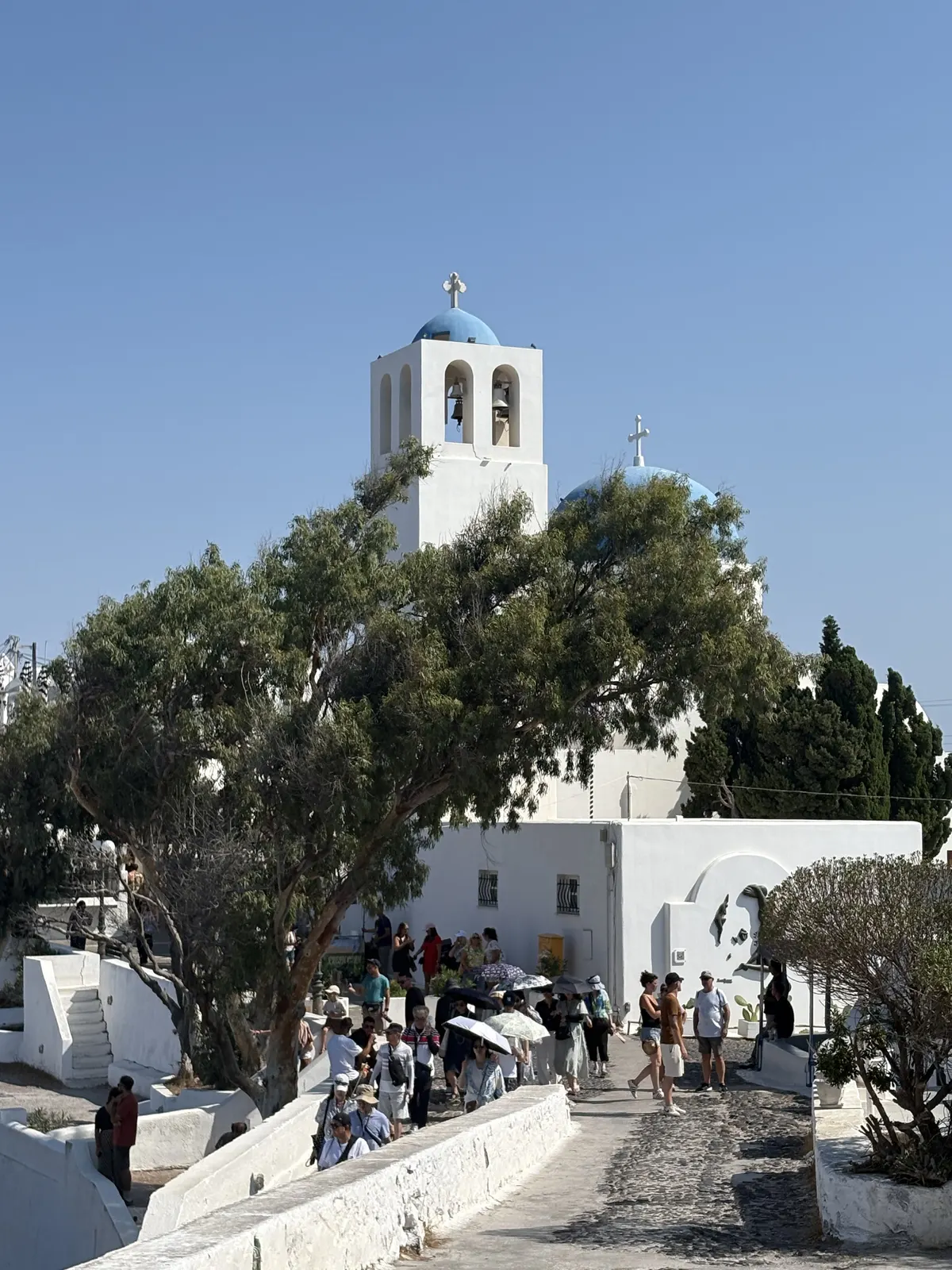 Blue-domed church on the walking path in Santorini