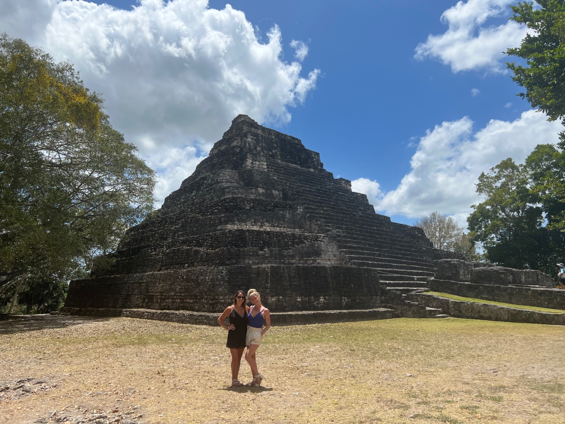 Standing with a friend in front of a Mayan pyramid at Chacchoben