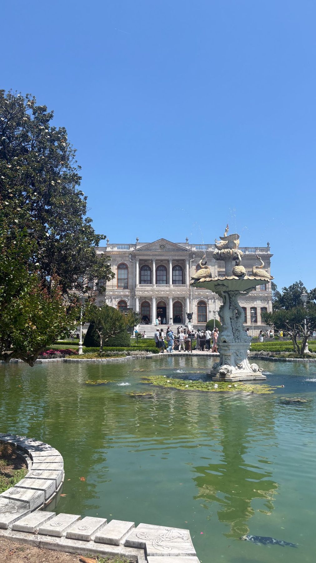 A palace fountain and reflecting pool at Dolmabahce