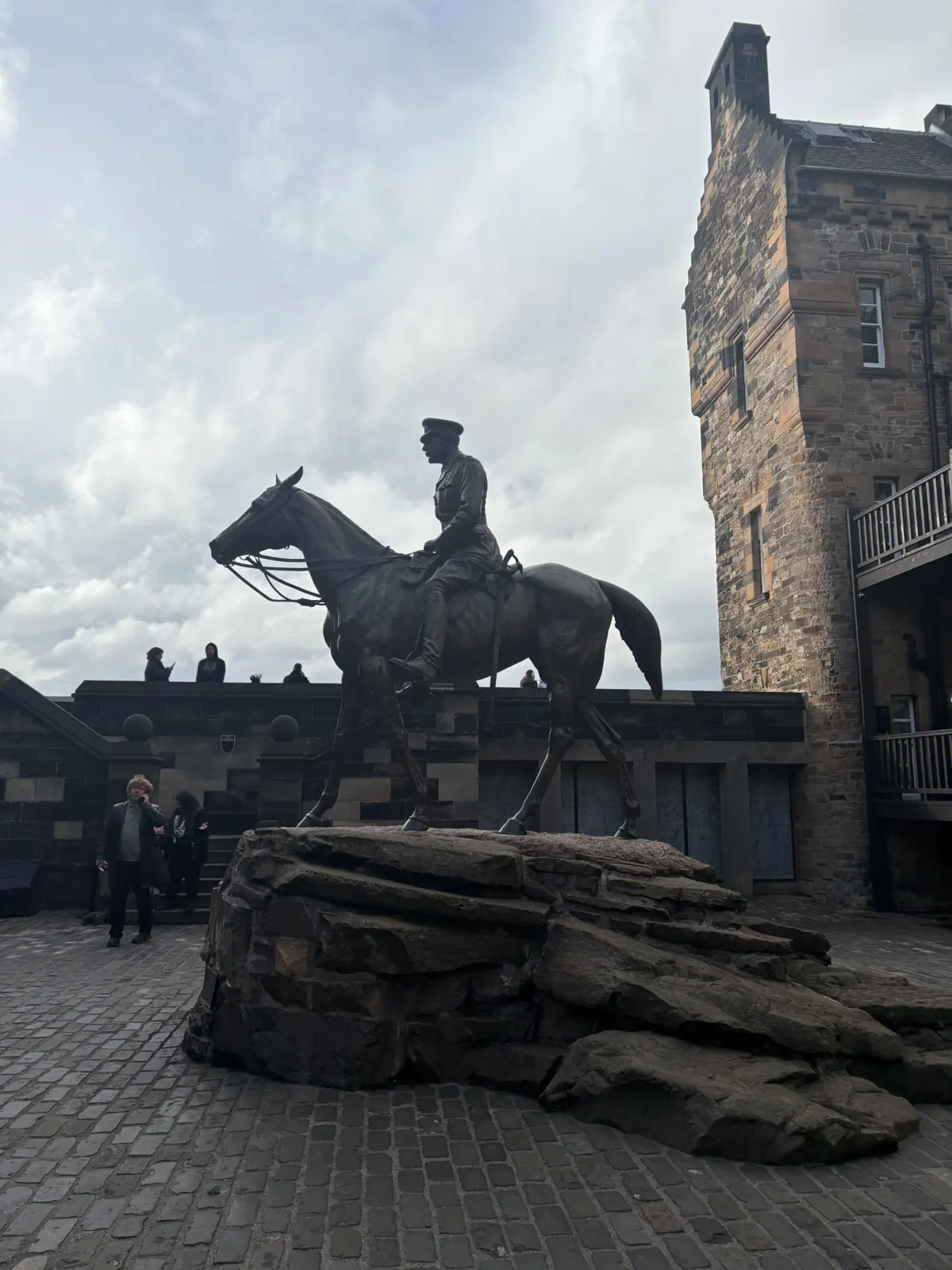 Bronze equestrian statue on rough stone inside Edinburgh Castle