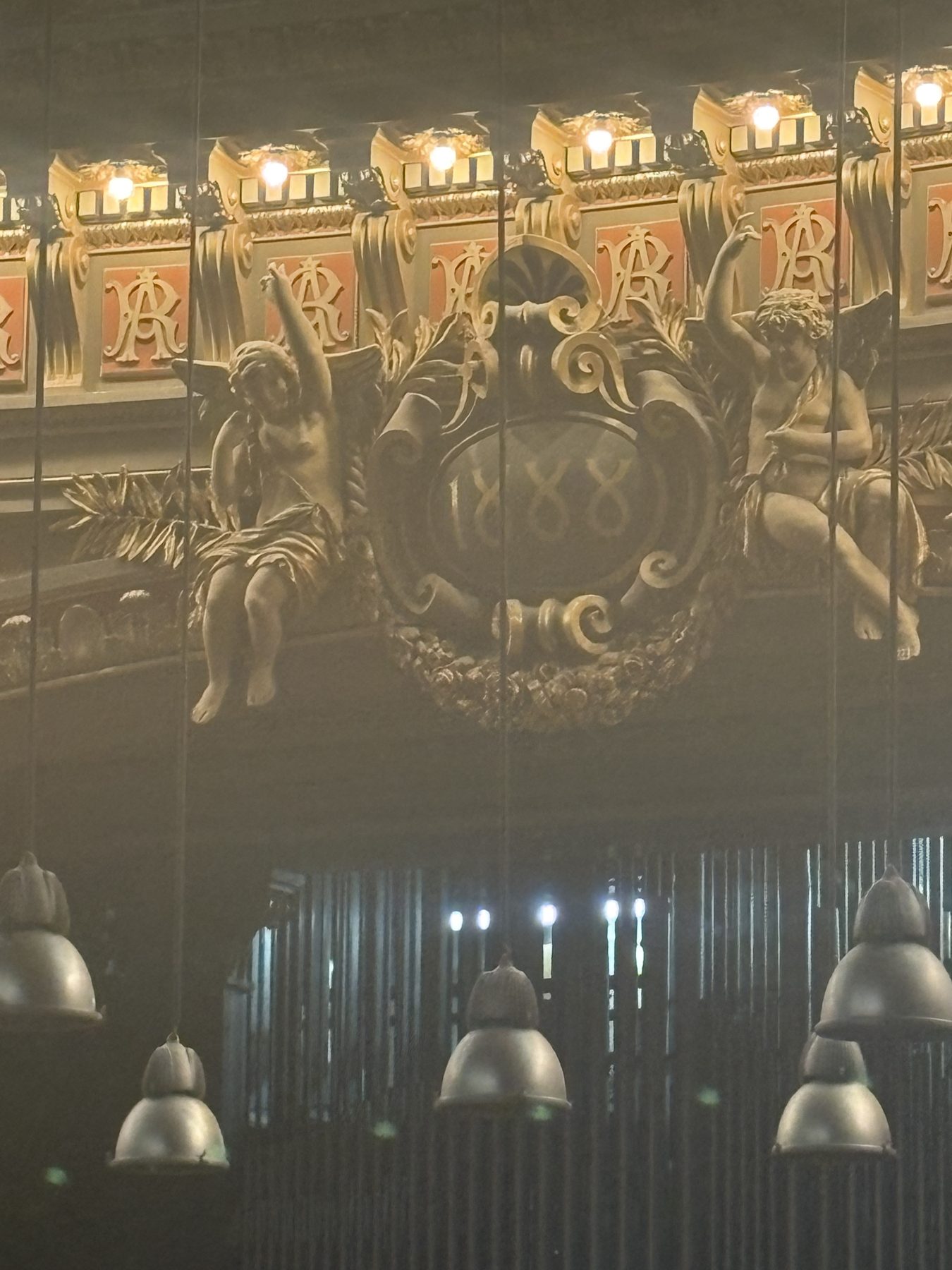 An ornate gilded interior with mirrors and lamps in Bucharest