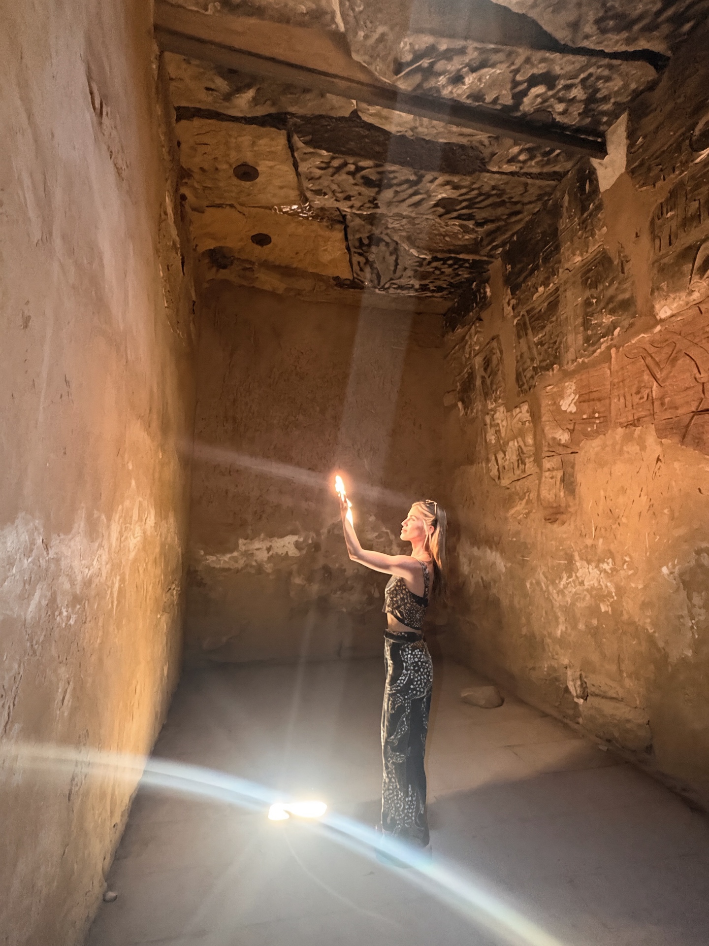 Holding a light inside an ancient Egyptian temple corridor