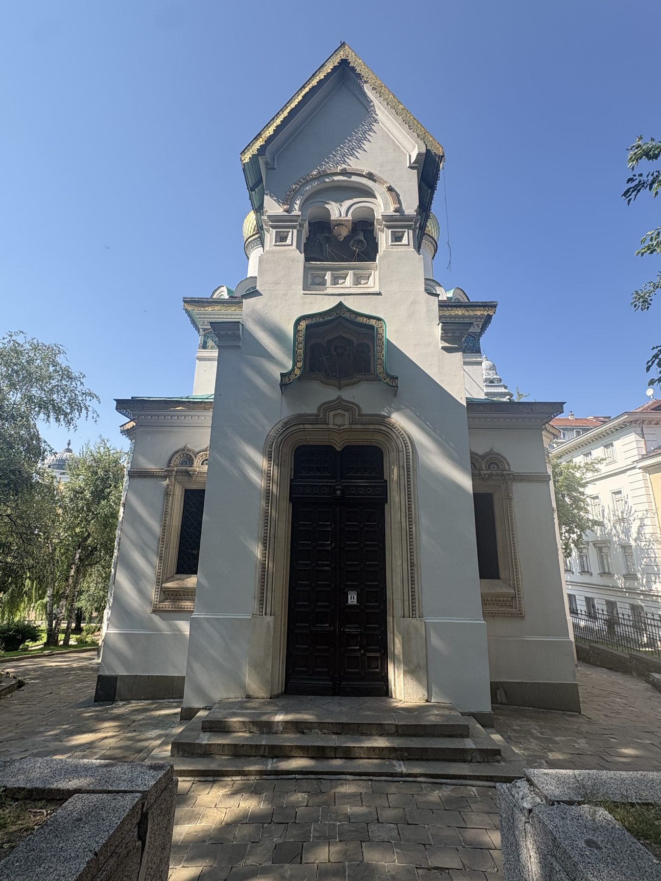 A white stone monument spire in a Sofia park
