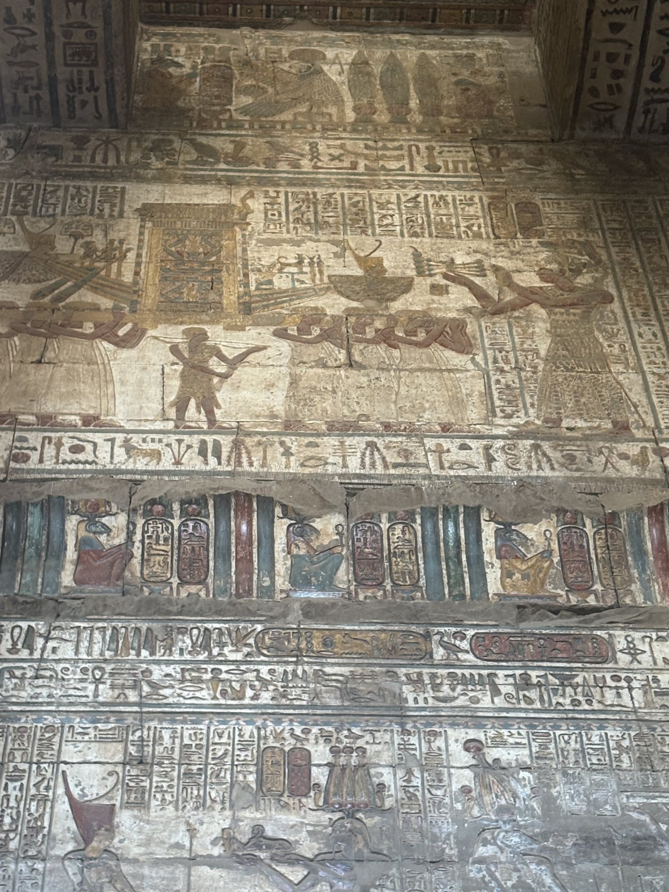 Dense carved reliefs covering a wall at Dendera