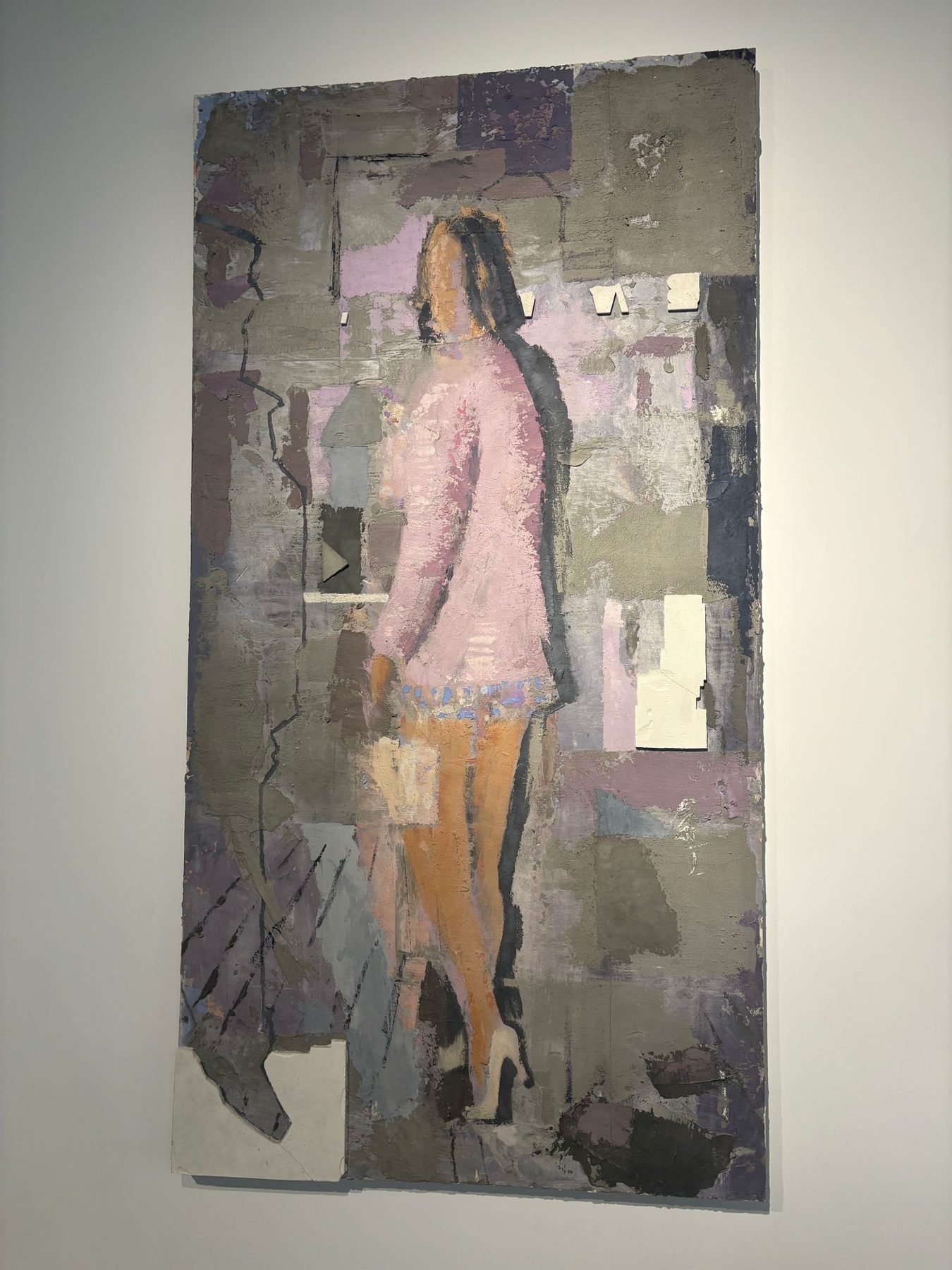A mixed-media collage of a standing woman