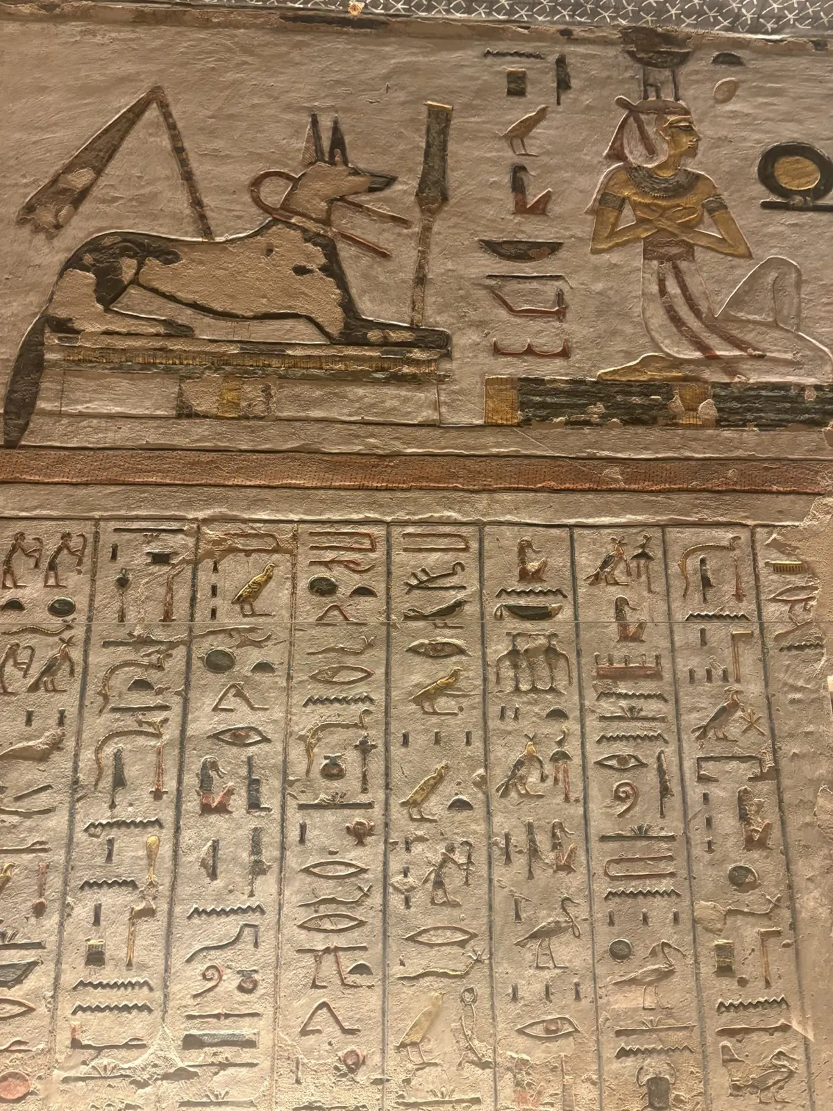 A painted figure of Anubis on a tomb wall