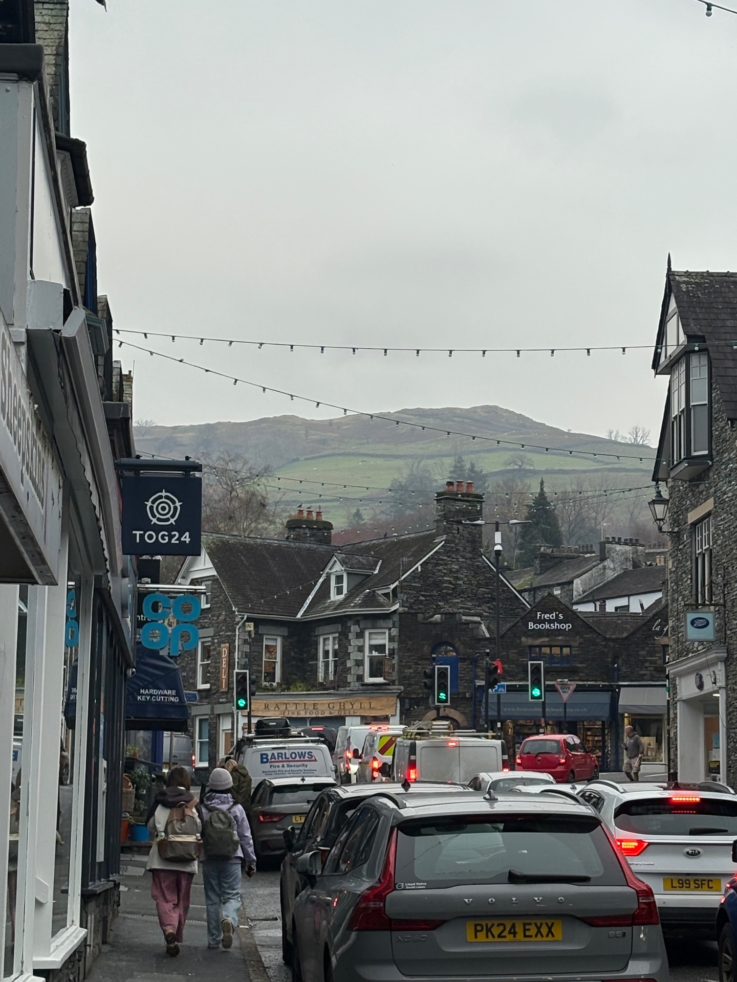 Ambleside high street with the fells rising behind the rooftops
