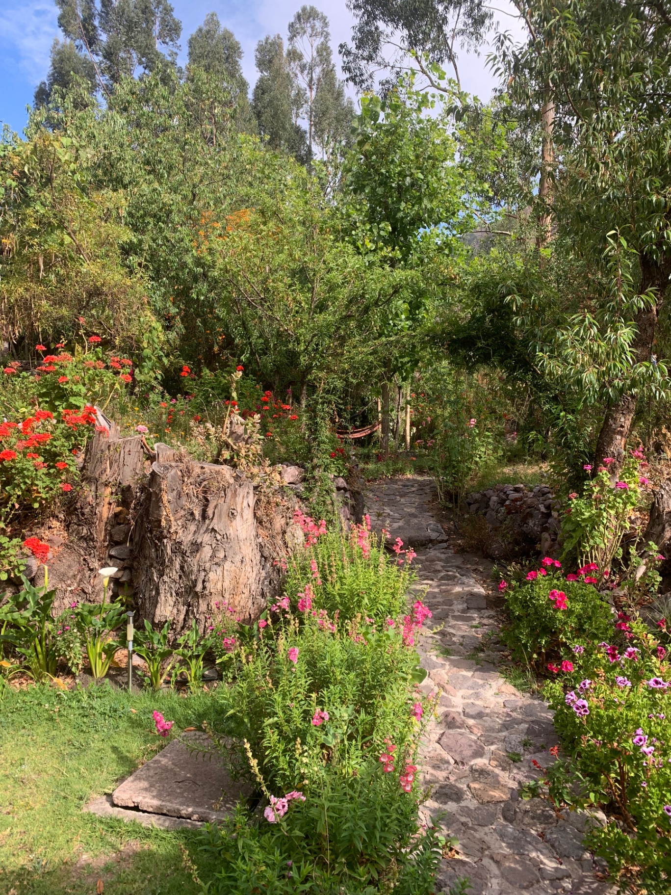 Flower-lined stone path through the retreat gardens in the Sacred Valley
