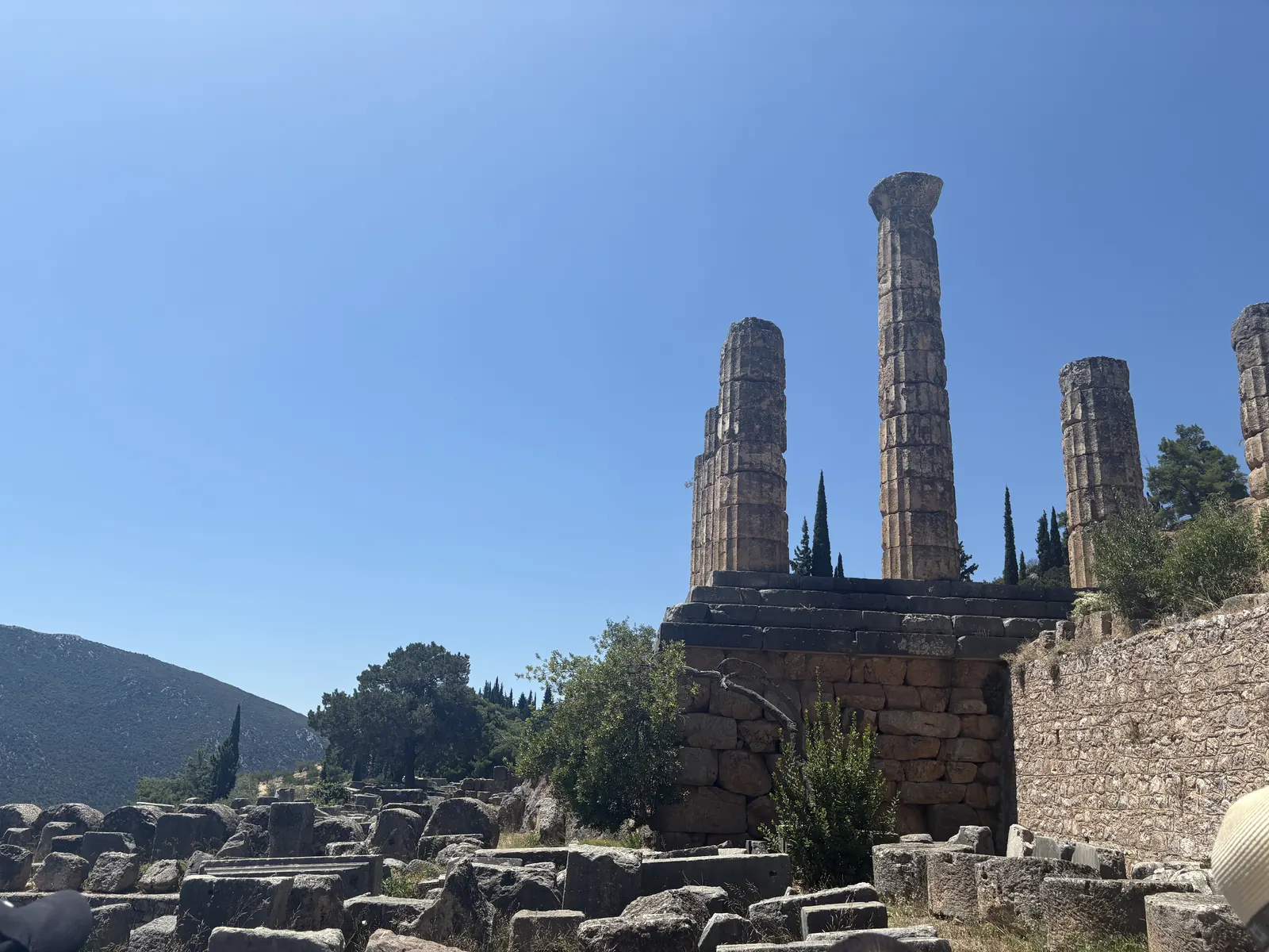 The Temple of Apollo framed by cypress trees