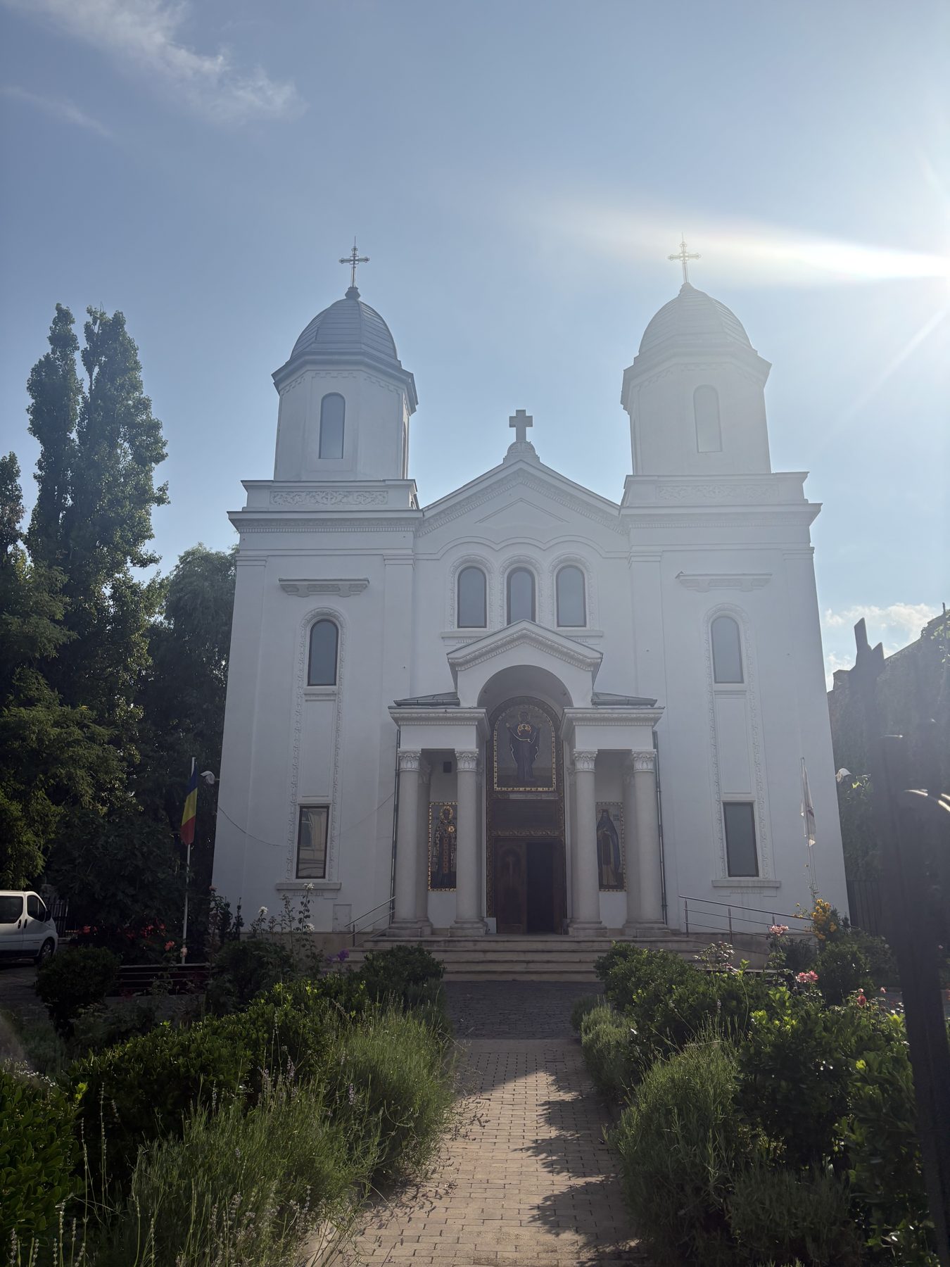 A white Orthodox church with twin towers in Bucharest
