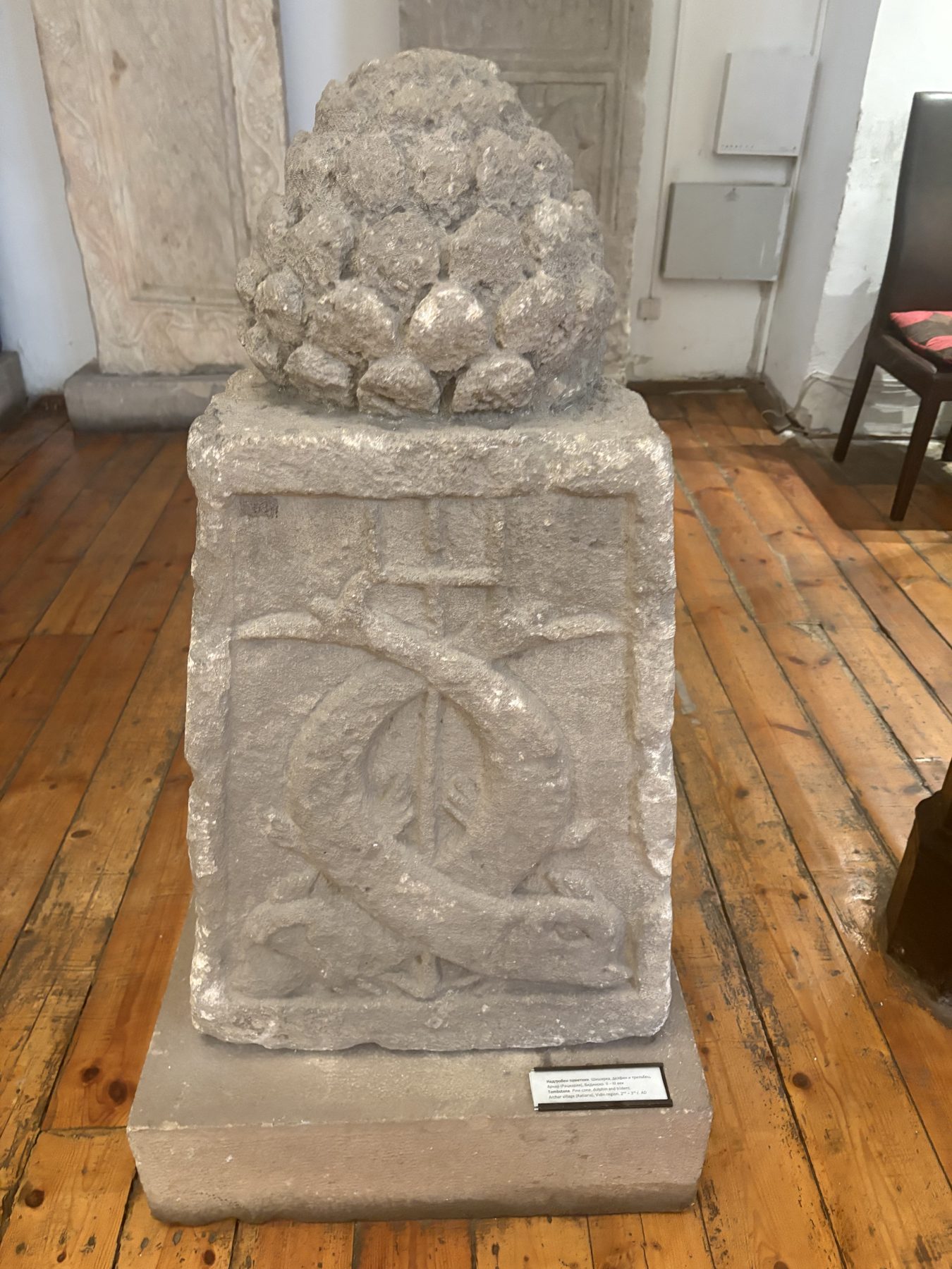 An ornate carved stone panel in a museum display
