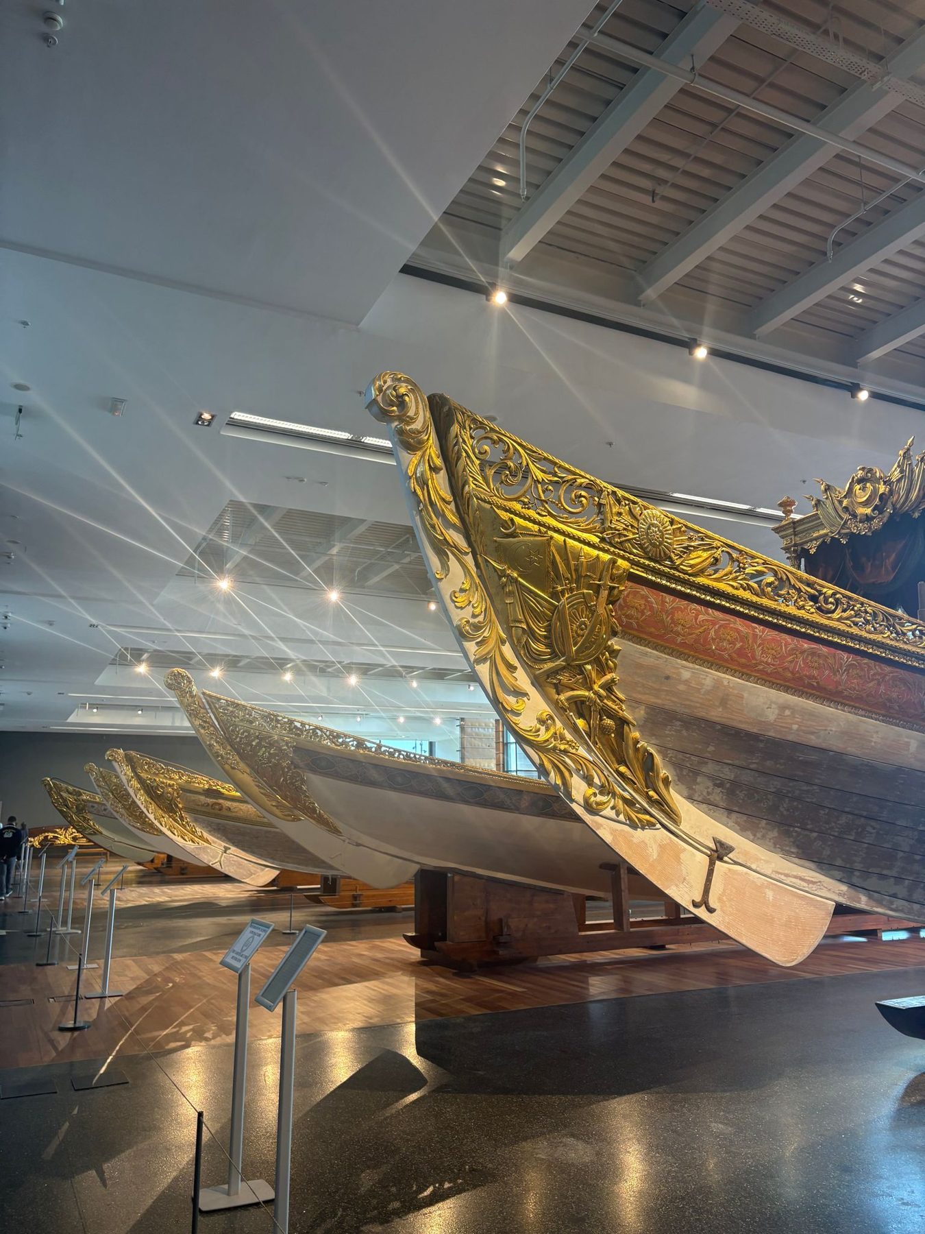 A gilded imperial caique boat displayed in a museum